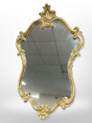 A reproduction gilt cartouche-shaped mirror,