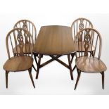 An Ercol stained elm drop leaf table and four spindle back chairs