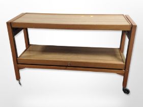 A teak-effect two-tier serving trolley, length 116cm.