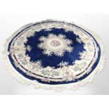 A Chinese circular rug on blue ground,