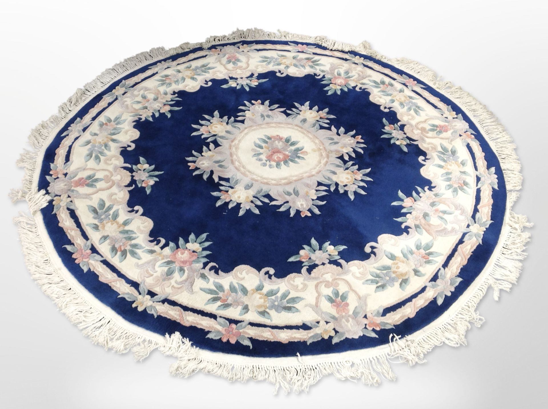 A Chinese circular rug on blue ground,