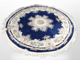 A Chinese circular rug on blue ground,