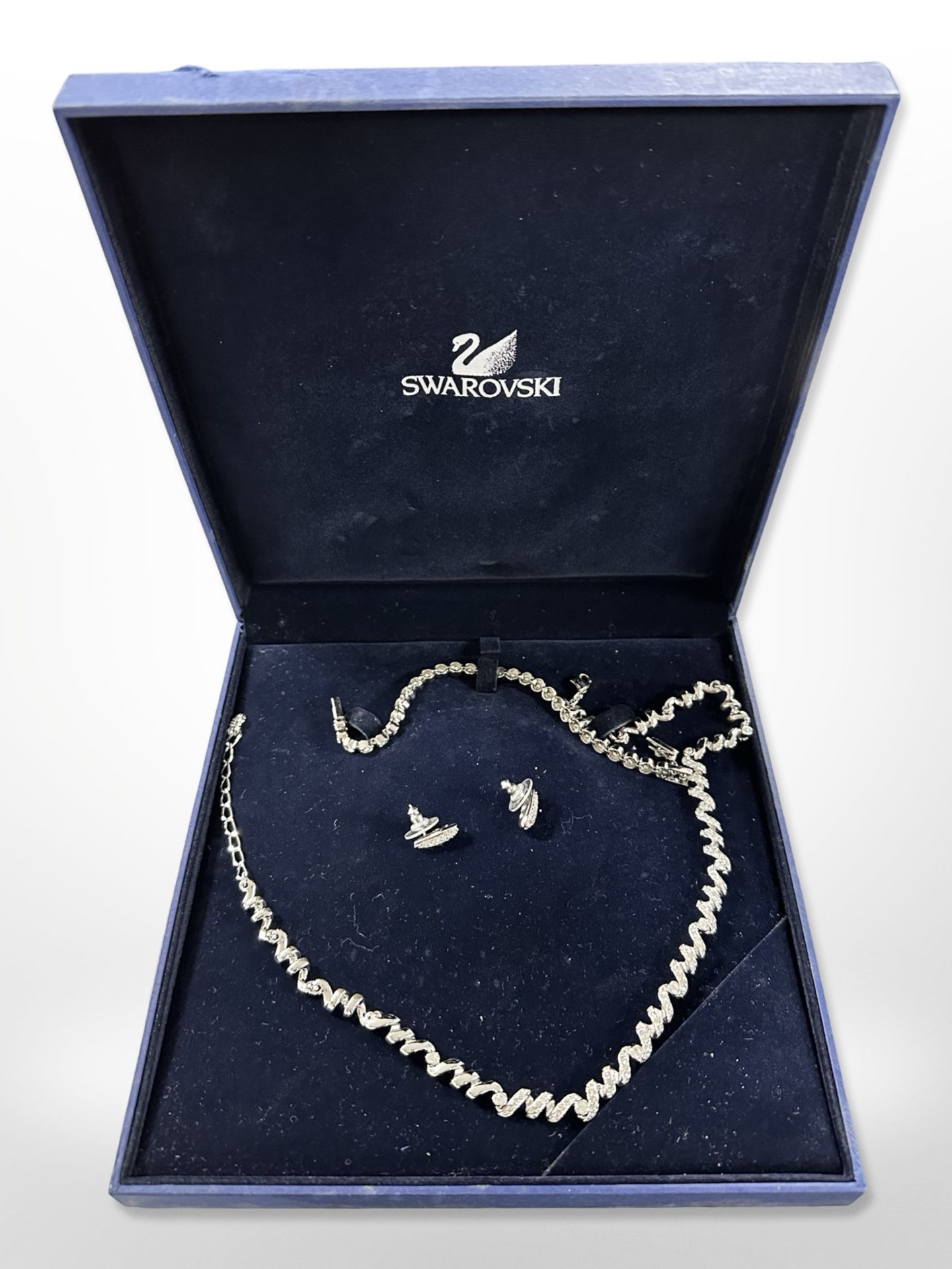 A Swarovksi crystal necklace, bracelet and pair of earrings, in box.