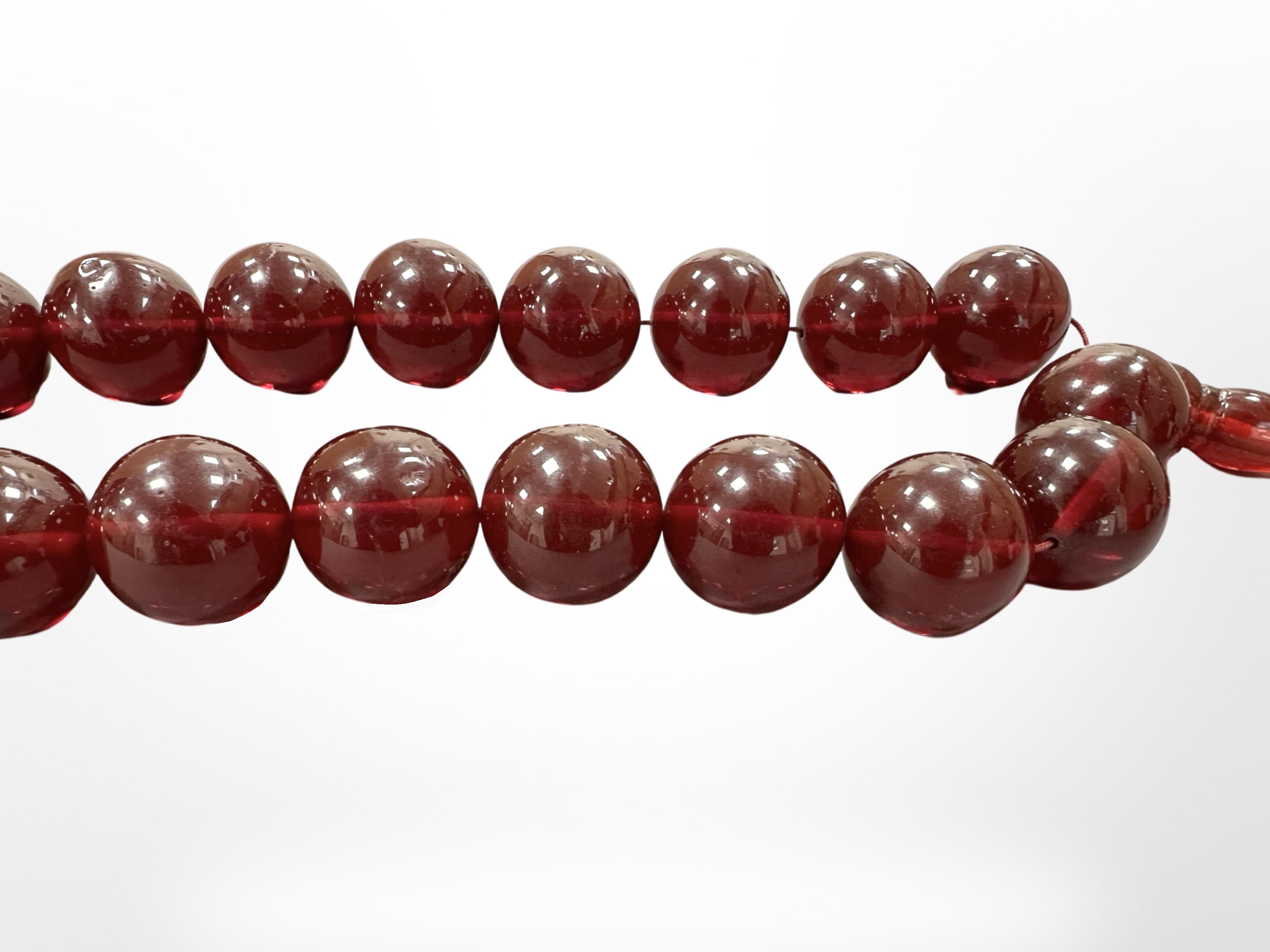 An impressive large cherry amber necklace with thirty three large spherical beads, - Image 3 of 4