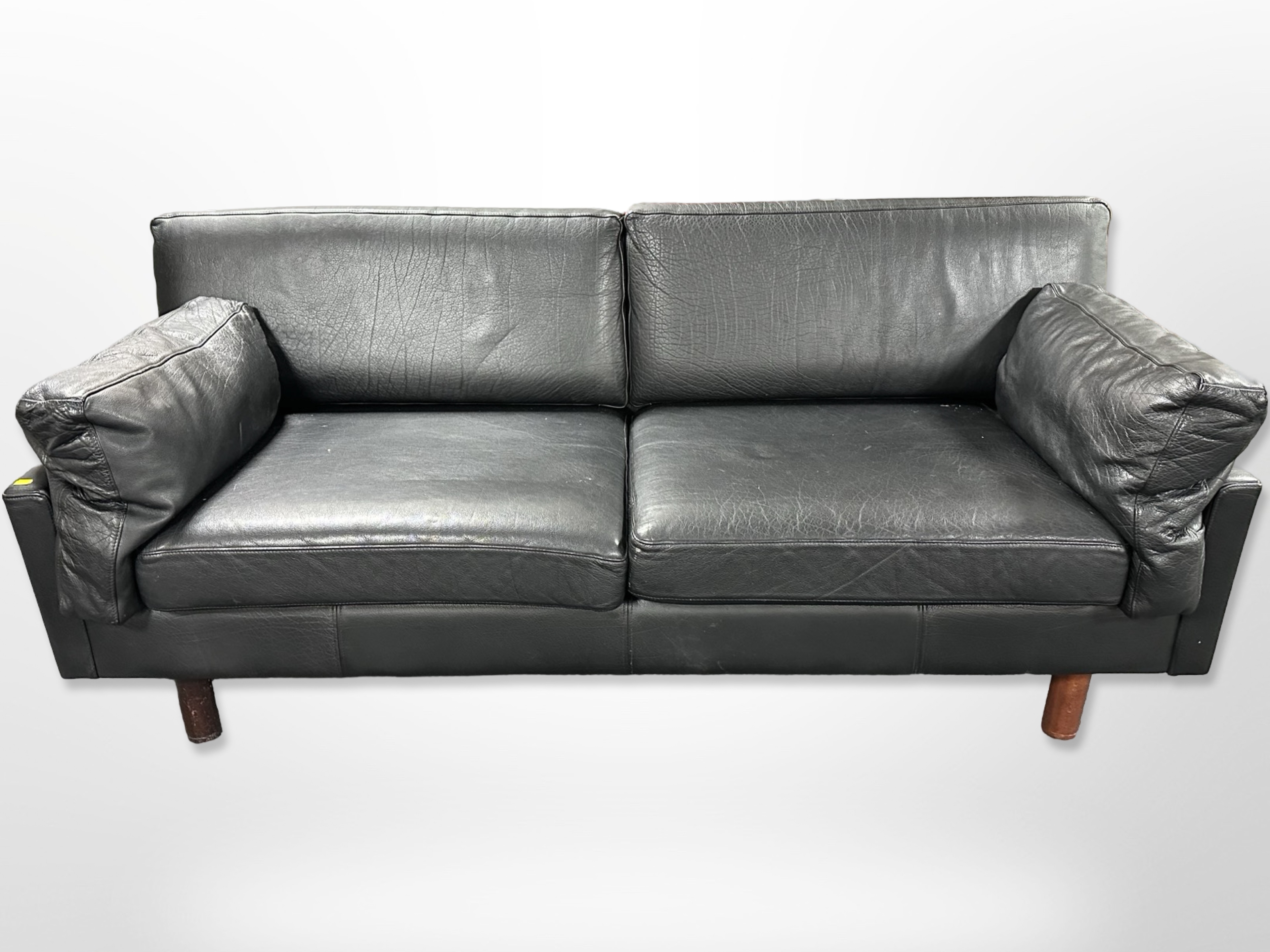 A contemporary Scandinavian black stitched leather three-seater settee,