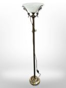 A contemporary brass standard lamp with frosted glass shade,