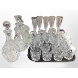 A collection of crystal drinking glasses, two decanters, and a lidded jar, etc.