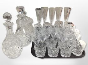 A collection of crystal drinking glasses, two decanters, and a lidded jar, etc.