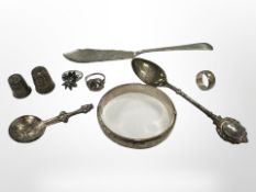 A group of silver items to include bangle, two thimbles, three rings, fish knife, two spoons.