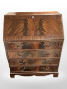 A reproduction mahogany bureau,