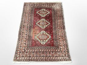 An Afghan rug of geometric design,