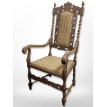 A continental heavily carved beech armchair in studded upholstery,