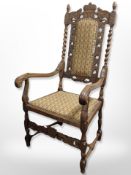 A continental heavily carved beech armchair in studded upholstery,