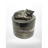 A silver cylindrical pot surmounted by a cat, height 5 cm, Sarah Jones, London 1993.