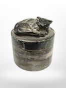 A silver cylindrical pot surmounted by a cat, height 5 cm, Sarah Jones, London 1993.