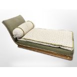 An early-20th century walnut chaise longue, with bolster cushion,