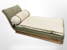 An early-20th century walnut chaise longue, with bolster cushion,