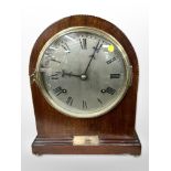 An early 20th-century inlaid mahogany eight-day mantel clock, height 30cm.