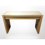 A contemporary oak veneered desk with glass top,