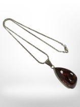 A Sterling silver necklace with silver mounted amber pendant.