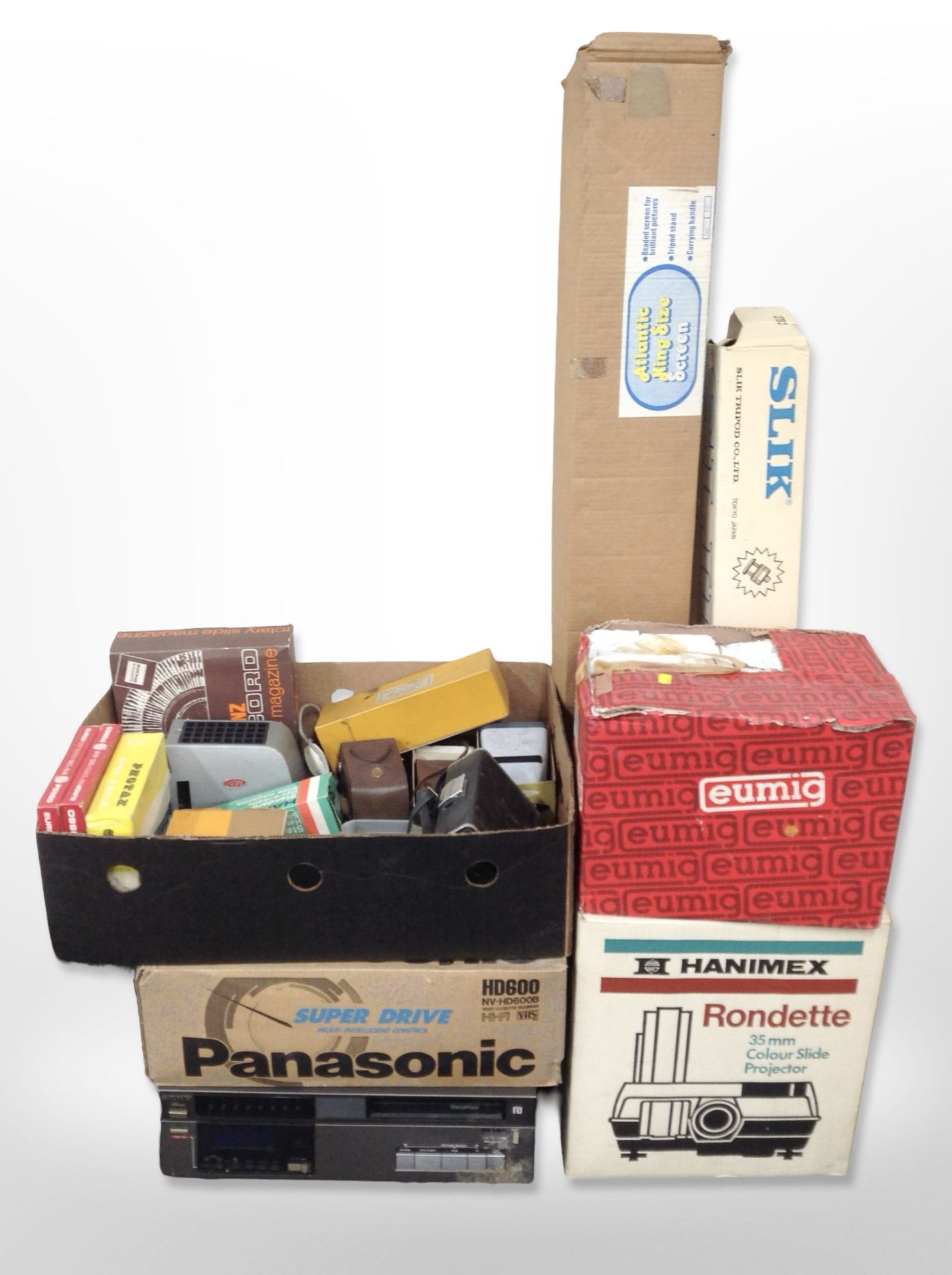 A collection of projector and photographic items including Eumig and Hanimex projectors in boxes,