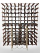 Four wood and metal bottle racks, each 42cm x 51cm, together with a further wicker bottle rack.