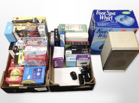 A group of board games, Nintendo Wii Zapper, together with a foot spa and a speaker.