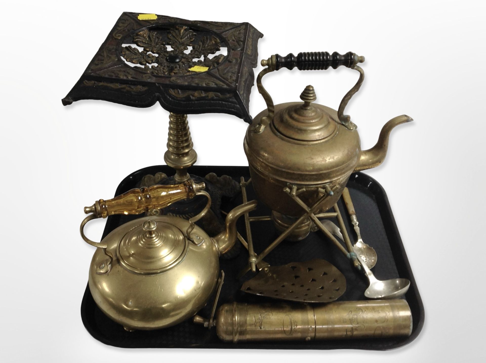 A 19th-century cast-iron and brass trivet, brass kettle on burner stand, a further kettle,