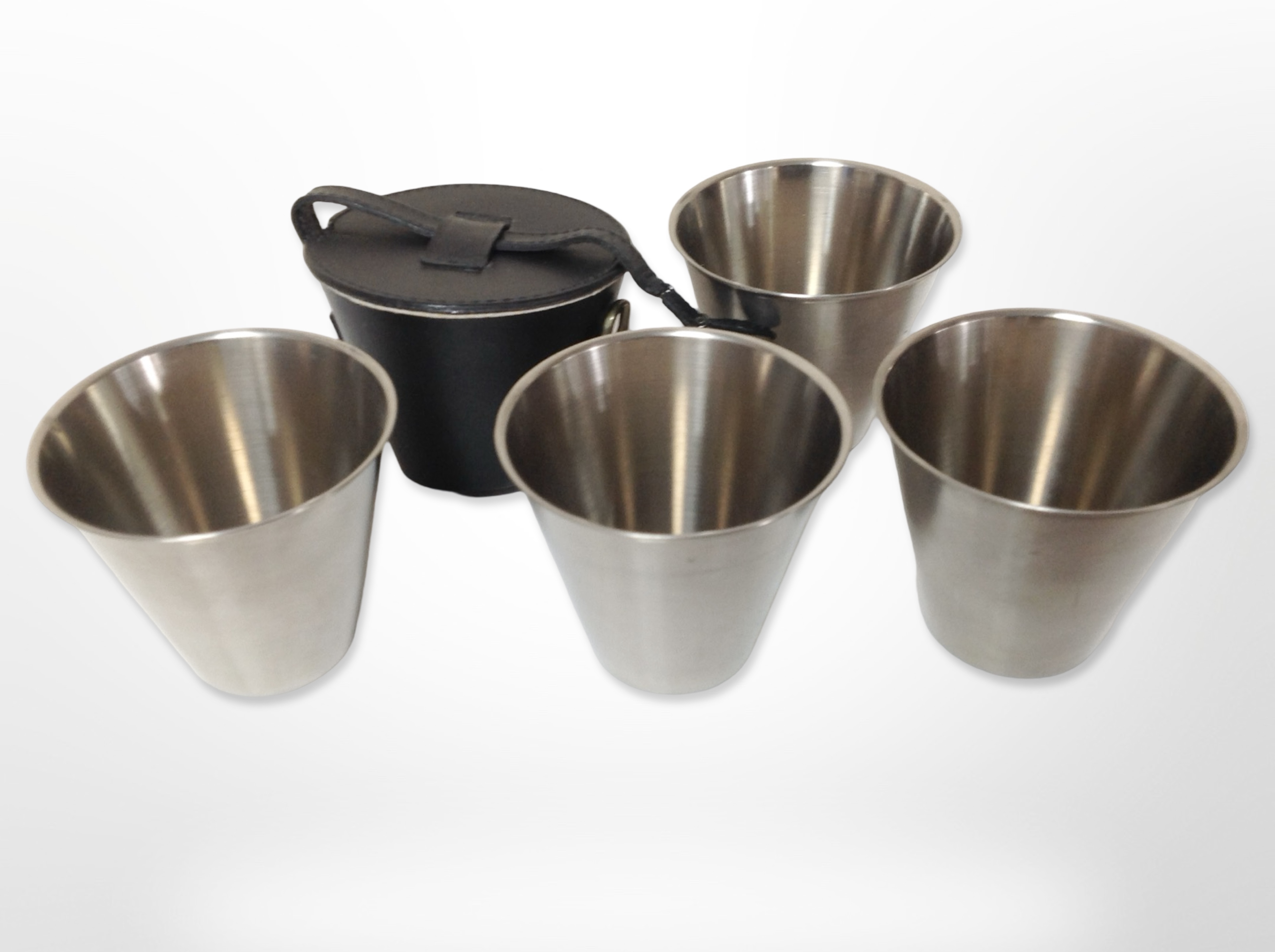 A set of four Harrods travelling drinking cups in leather case.