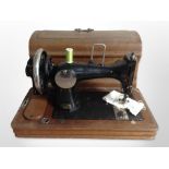 A Vesta hand sewing machine in oak box.