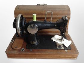 A Vesta hand sewing machine in oak box.