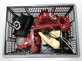 A group of vintage plastic telephones.