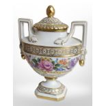 A Dresden hand-painted and gilt floral twin-handled lidded urn, height 19cm.