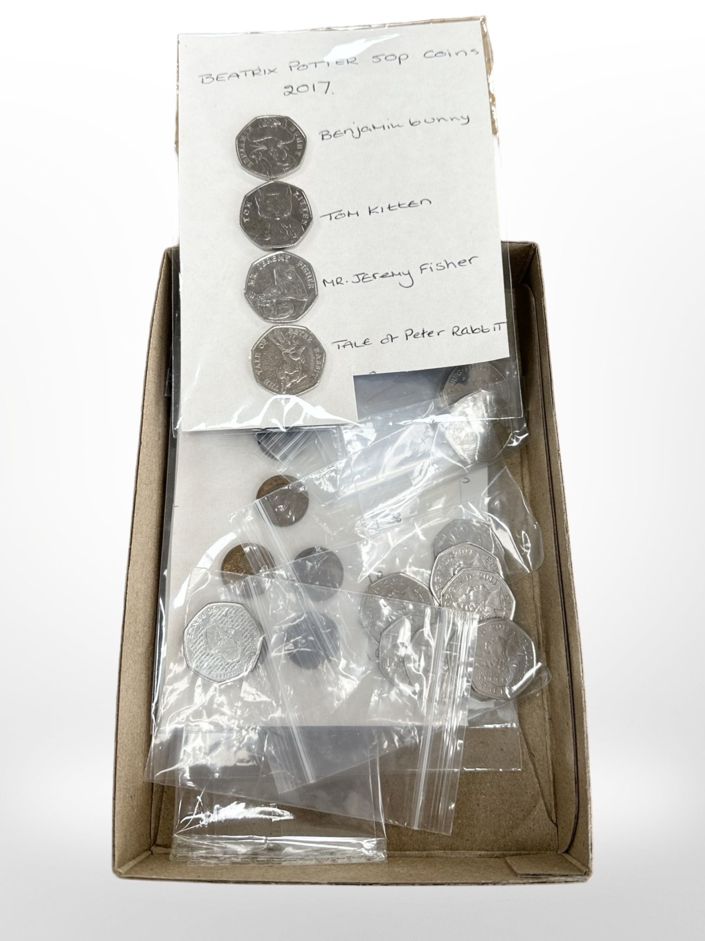 A collection of 50p coins, Beatrix Potter etc.