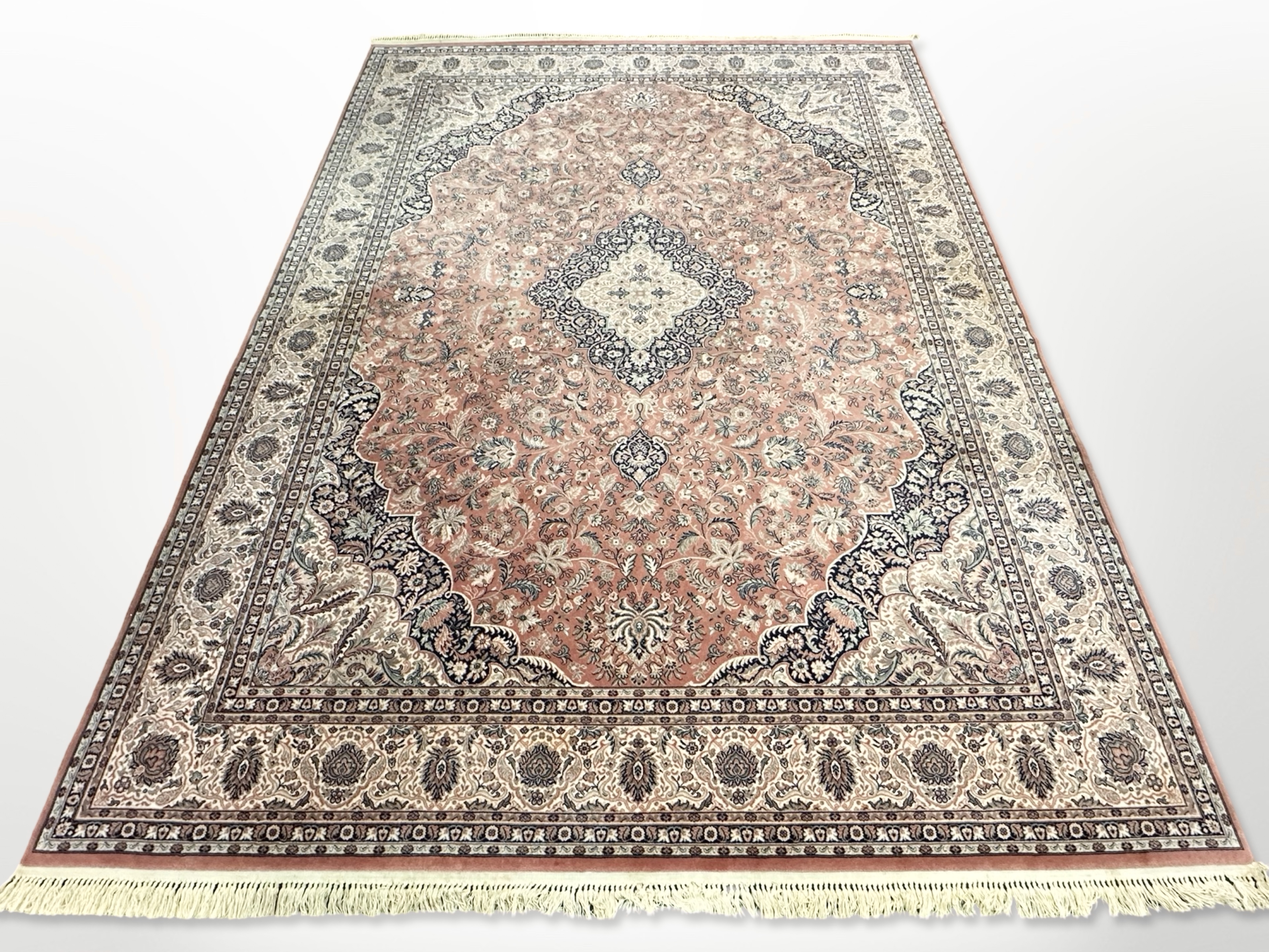 A machine made carpet of Persian design,