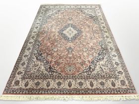 A machine made carpet of Persian design,