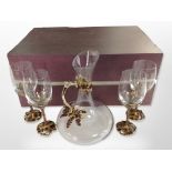 A set of four contemporary crystal and enamelled metal grape and leaf pattern wine glasses with