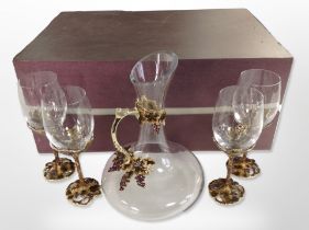 A set of four contemporary crystal and enamelled metal grape and leaf pattern wine glasses with