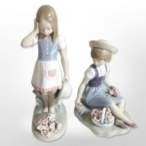 Two Lladró figures of girls picking flowers.