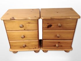 A pair of contemporary pine three drawer bedside chest,