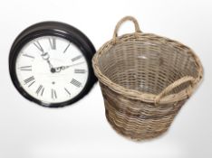 A large contemporary quartz wall clock, diameter 48cm, together with a wicker laundry basket.