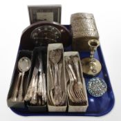 A quantity of EPNS cutlery, paperweight, brass candlestick and table box,