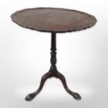 A George III style mahogany pedestal table with pie crust top,