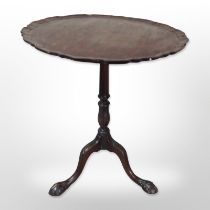 A George III style mahogany pedestal table with pie crust top,