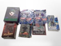 Seven Mattel, Toybiz and other figurines including Batman, He-Man, the Flash, etc., boxed.
