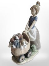 A Lladró figure of a girl with puppies in a basket, no. 5364.