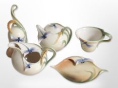 A group of Franz porcelain items decorated with dragonflies, to include teacup and saucer, bell,