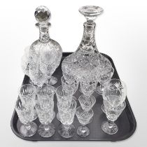 A crystal ship's decanter, one other, and assorted drinking glasses.