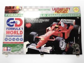 A 1:6 scale radio controlled Formula 1 car, in box.