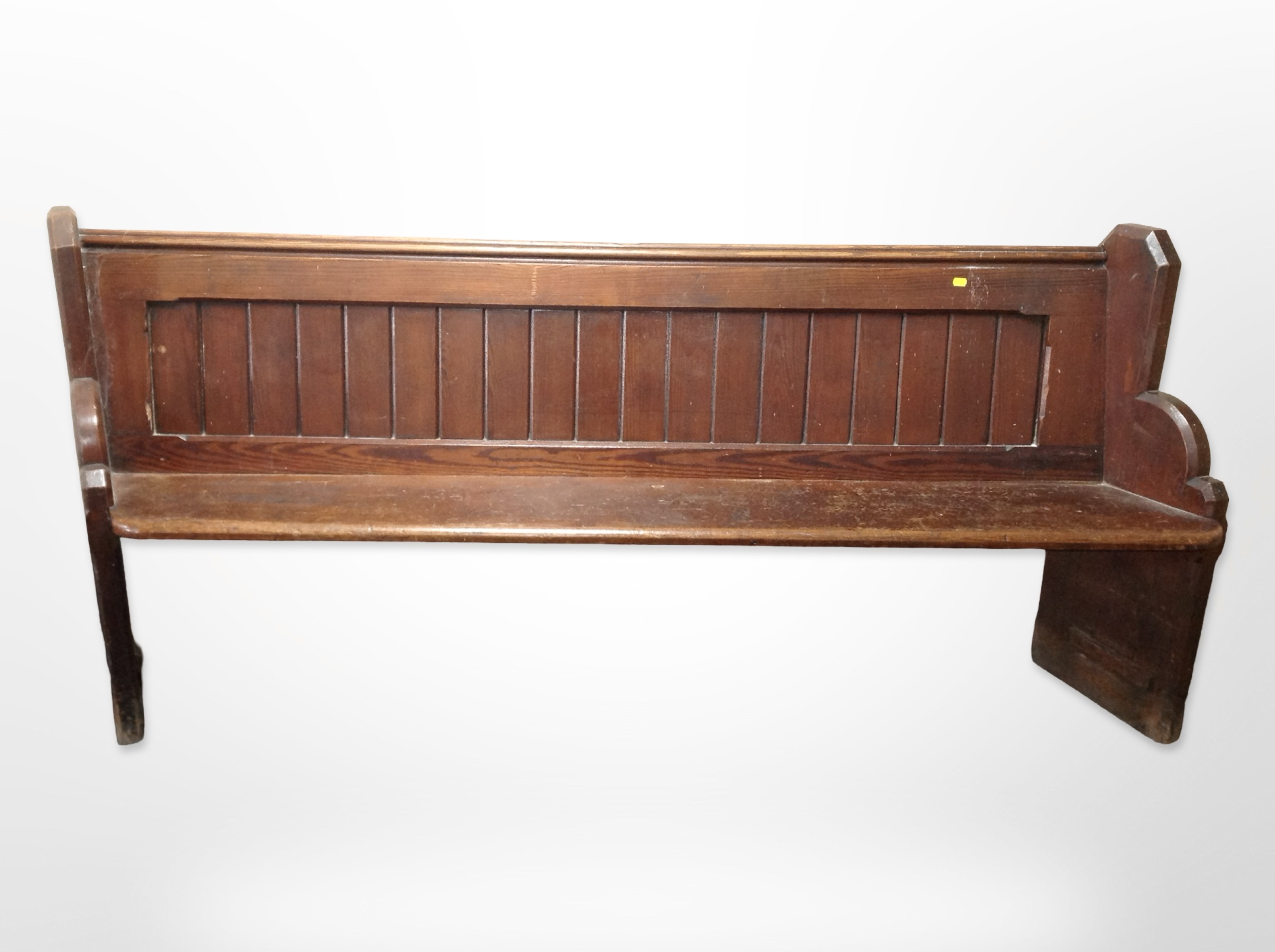 A Victorian pitch pine pew with canted ends,